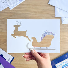 Load image into Gallery viewer, Santa&#39;s Sleigh with Reindeer Aperture Card (Pack of 3) | 3 x Square PRINTED Christmas Apertures, Coloured Card Blanks &amp; White Envelopes | Night Sky Edition | Blue Purple Teal
