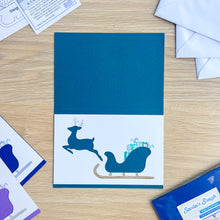 Load image into Gallery viewer, Santa&#39;s Sleigh with Reindeer Aperture Card (Pack of 3) | 3 x Square PRINTED Christmas Apertures, Coloured Card Blanks &amp; White Envelopes | Night Sky Edition | Blue Purple Teal
