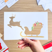 Load image into Gallery viewer, Santa&#39;s Sleigh with Reindeer Aperture Card (Pack of 3) | 3 x Square PRINTED Apertures, Coloured Card Blanks &amp; White Envelopes | Traditional Christmas Edition | Red Green Gold
