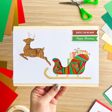 Load image into Gallery viewer, Santa&#39;s Sleigh with Reindeer Aperture Card (Pack of 3) | 3 x Square PRINTED Apertures, Coloured Card Blanks &amp; White Envelopes | Traditional Christmas Edition | Red Green Gold
