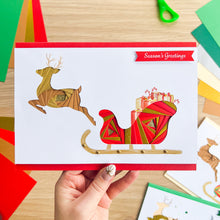 Load image into Gallery viewer, Santa&#39;s Sleigh with Reindeer Aperture Card (Pack of 3) | 3 x Square PRINTED Apertures, Coloured Card Blanks &amp; White Envelopes | Traditional Christmas Edition | Red Green Gold
