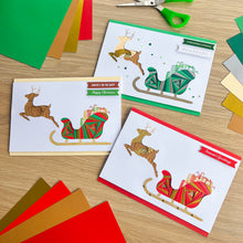 Load image into Gallery viewer, Santa&#39;s Sleigh with Reindeer Aperture Card (Pack of 3) | 3 x Square PRINTED Apertures, Coloured Card Blanks &amp; White Envelopes | Traditional Christmas Edition | Red Green Gold
