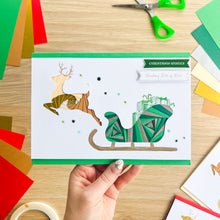 Load image into Gallery viewer, Santa&#39;s Sleigh with Reindeer Aperture Card (Pack of 3) | 3 x Square PRINTED Apertures, Coloured Card Blanks &amp; White Envelopes | Traditional Christmas Edition | Red Green Gold
