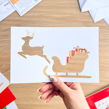 Load image into Gallery viewer, Santa&#39;s Sleigh with Reindeer Aperture Card (Pack of 3) | 3 x Square PRINTED Apertures, Coloured Card Blanks &amp; White Envelopes | Traditional Christmas Edition | Red Green Gold
