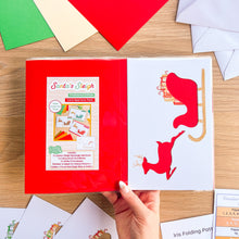 Load image into Gallery viewer, Santa&#39;s Sleigh with Reindeer Aperture Card (Pack of 3) | 3 x Square PRINTED Apertures, Coloured Card Blanks &amp; White Envelopes | Traditional Christmas Edition | Red Green Gold
