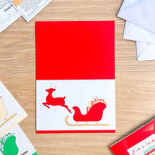 Load image into Gallery viewer, Santa&#39;s Sleigh with Reindeer Aperture Card (Pack of 3) | 3 x Square PRINTED Apertures, Coloured Card Blanks &amp; White Envelopes | Traditional Christmas Edition | Red Green Gold
