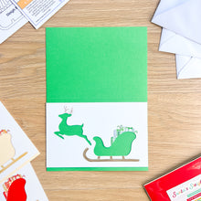 Load image into Gallery viewer, Santa&#39;s Sleigh with Reindeer Aperture Card (Pack of 3) | 3 x Square PRINTED Apertures, Coloured Card Blanks &amp; White Envelopes | Traditional Christmas Edition | Red Green Gold
