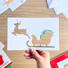 Load image into Gallery viewer, Santa&#39;s Sleigh with Reindeer Aperture Card (Pack of 3) | 3 x Square PRINTED Apertures, Coloured Card Blanks &amp; White Envelopes | Traditional Christmas Edition | Red Green Gold
