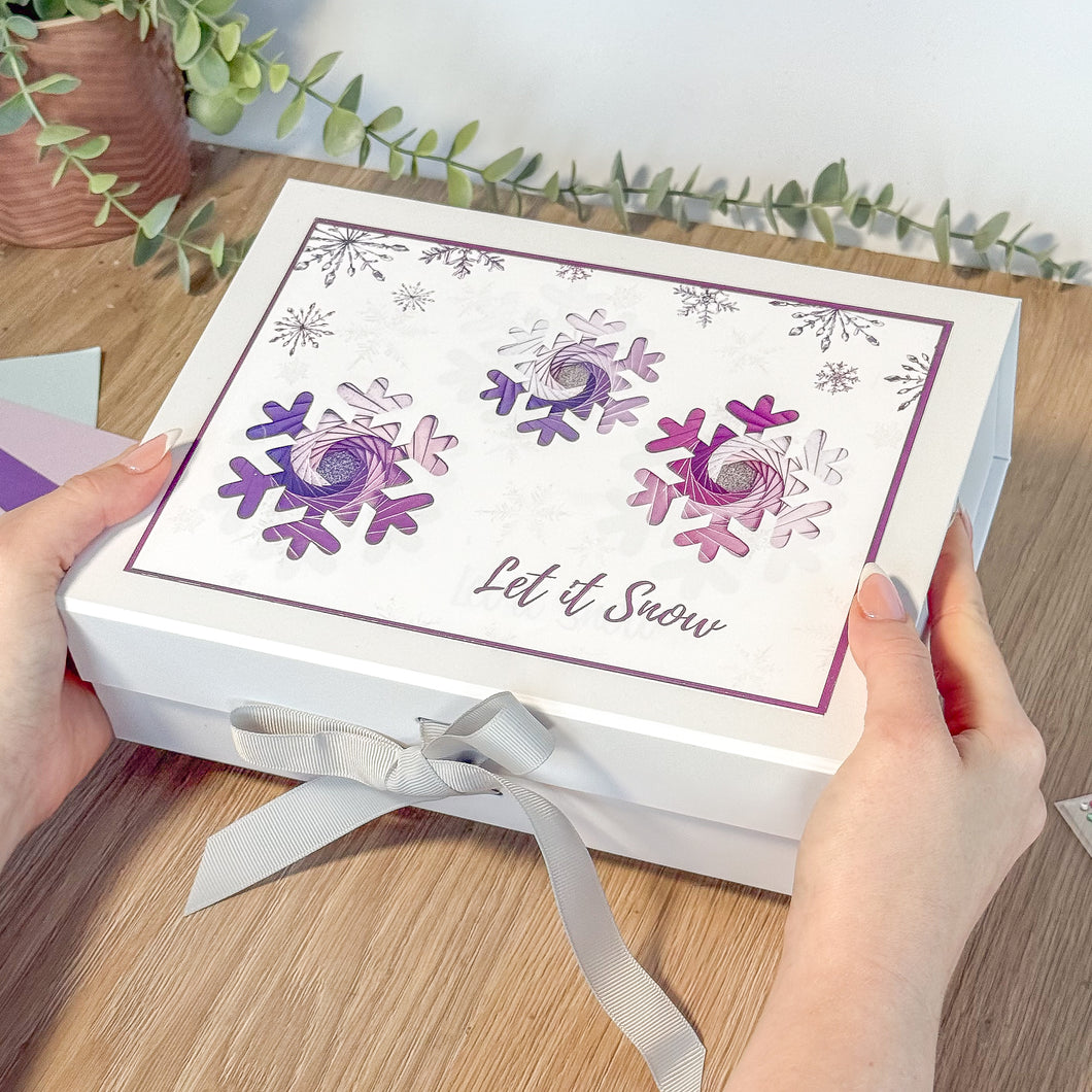 White Gift Box with three purple snowflakes and text 'Let it Snow'