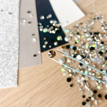 Load image into Gallery viewer, close-up of a tweezers holding a silver rhinestone gem
