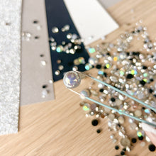 Load image into Gallery viewer, Close-up of a pearlescent gem held by tweezers
