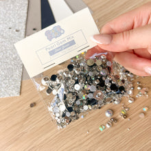 Load image into Gallery viewer, Hand holding a package of pearl gem mix on a wooden surface
