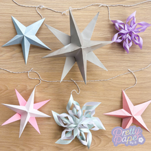Load image into Gallery viewer, Six stars and snowflakes from the star  and snowflake paper garland craft kit
