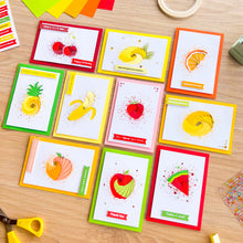 Load image into Gallery viewer, Set of colourful iris folding greeting cards with fruit illustrations on a wooden surface.
