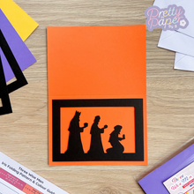 Load image into Gallery viewer, three wise men silhouette aperture on orange card blank

