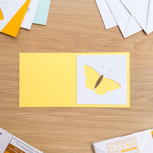 Load image into Gallery viewer, Butterfly aperture cut-out on yellow card blank
