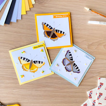 Load image into Gallery viewer, Three tortoiseshell butterfly iris folding greeting cards on a wooden table with craft supplies
