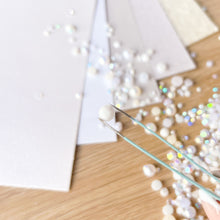 Load image into Gallery viewer, Crafting activity with pearls and tweezers on a wooden surface
