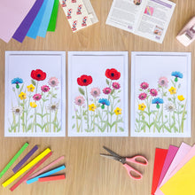 Load image into Gallery viewer, Triptych of iris folding wildflower pictures on a wooden surface with craft supplies.
