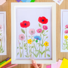 Load image into Gallery viewer, Framed iris fold picture of colorful flowers on a wooden surface.
