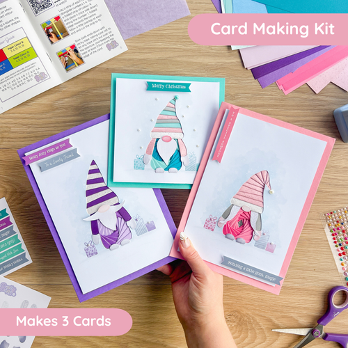 Card making kit with gonk or gnome-themed cards on a wooden table
