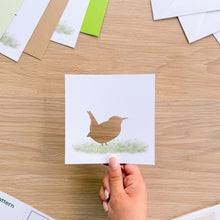 Load image into Gallery viewer, A wren cutout on white card with watercolour grass.
