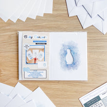 Load image into Gallery viewer, Baby penguin aperture card pack packaging on a wooden surface.
